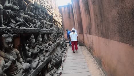 Tourists-stop-and-admire-the-stone-Buddhas-that-decorate-the-passages-towards-the-terrace-of-the-elephants