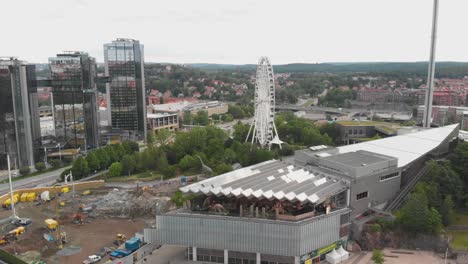 Aerial-video-of-construction-work-on-Korsvagen-for-Vastlanken,-in-the-central-part-of-Gothenburg,-Sweden,-with-Universeum-and-Gothia-towers-besides-it