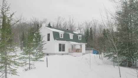 Residential-House-In-Pine-Forest-After-Heavy-Snow-In-Estrie,-Canada