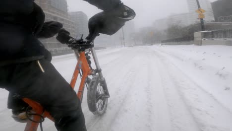 Side-Angle-POV-Of-Courier-Cycling-Radburro-During-Heavy-Snow-In-Downtown-Montreal
