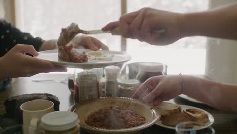 Baked-Beans-Being-Served-On-Plate-Indoors-To-Person