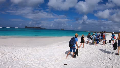 A-group-of-tourists-getting-ready-to-explore-the-white-sand-beach-of-the-Galapagos-Islands