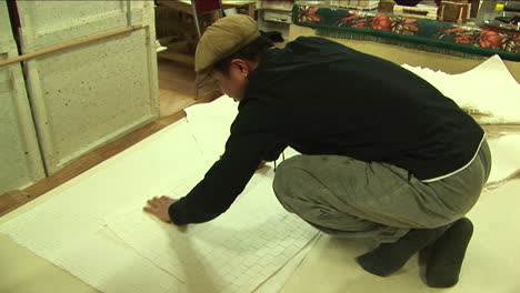 Worker-Checking-Paper-Quality,-Historical-Papermaking-Workshop-in-China