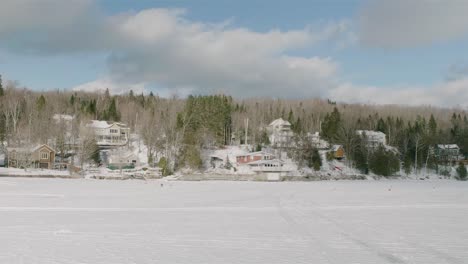Snow-Covered-Buildings-Viewed-From-Across-Frozen-White-Lake-Megantic-In-Quebec
