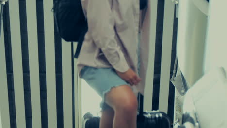 Young-Blonde-Female-Traveler-Standing-on-Airport-Escalator-SLOMO