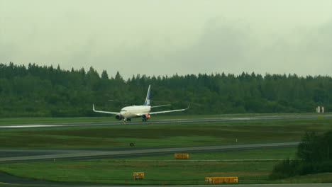 Scandinavian-Airlines-jet-at-end-of-runway-gets-clearance-to-take-off-and-accelerates-out-of-frame-as-camera-zooms-out