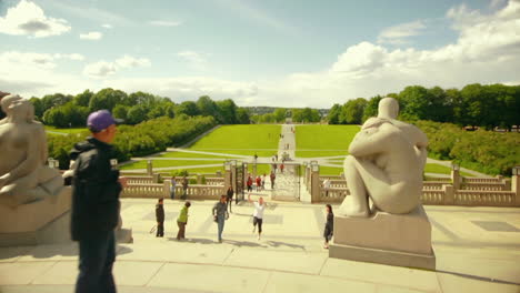 Casual-tourists-chilling-at-Frogner-Park-Oslo-Norway-with-parkour-stunts