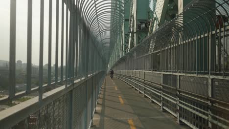 Cyclists-Going-Past-On-The-Cycle-Path-On-Jacques-Cartier-Bridge-In-Montreal