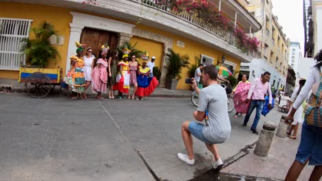 A-tourist-is-taking-a-picture-at-a-group-of-palenqueras-and-women-that-are-doing-tourism-in-Cartagena-de-Indias,-Colombia