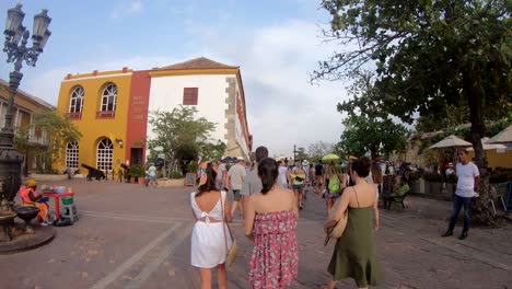 A-group-of-women,-friends-and-tourists-are-walking-down-the-street-in-the-old-town-of-Cartagena-de-Indias,-Colombia