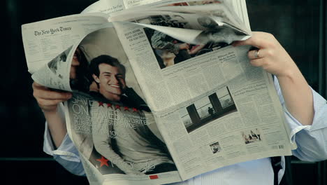 Anonymous-Man-Hiding-Face-Behind-Newspaper-in-Public