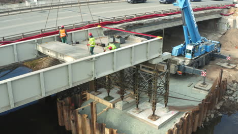 Construction-crew-installing-concrete-slab-in-roadside-bridge-formwork
