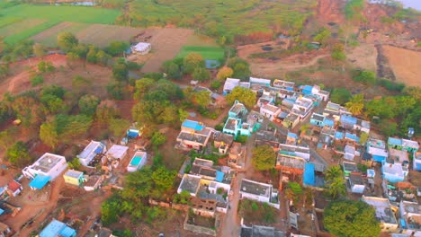 An-aerial-view-of-a-small-beautiful-village-surrounded-with-farmlands-and-water-sources