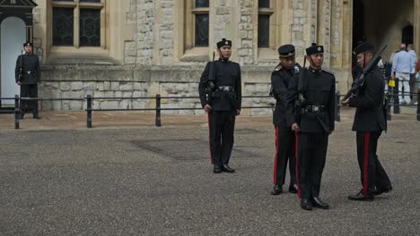 Oficiales-De-Guardia-Observando-Alrededor-De-Los-Guardias-Ingleses-De-Pie-Fuera-Del-Edificio-En-El-Reino-Unido