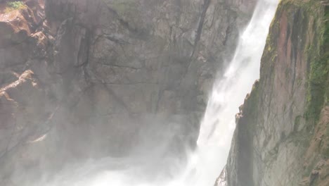 A-tourist-is-visiting-the-iconic-waterfall-in-Ecuador-called-Pailon-del-Diablo-in-Baños