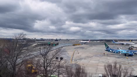 SLOW-MOTION-SHOT-OF-TERMINAL-3-JFK-AIRport-during-cloudy-day-from-train