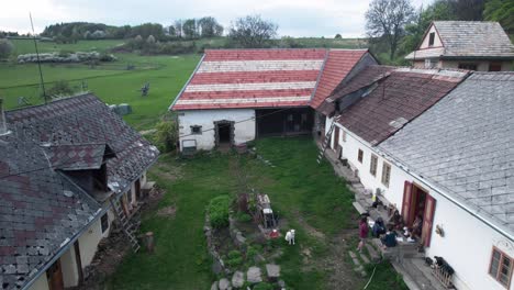 Rural-countryside-scene-with-people-talking-outside-garden-in-lower-tatra,-Slovakia