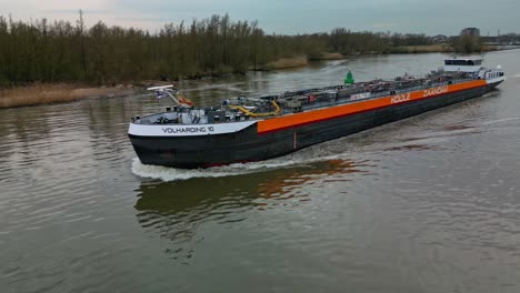 Aerial-view-of-a-liquid-oil-tanker-navigating-on-the-inland-canal-in-Zwijndrecht