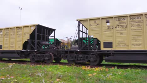 Two-freight-car-wagons-in-a-row,-wide-shot,-camera-pan-left