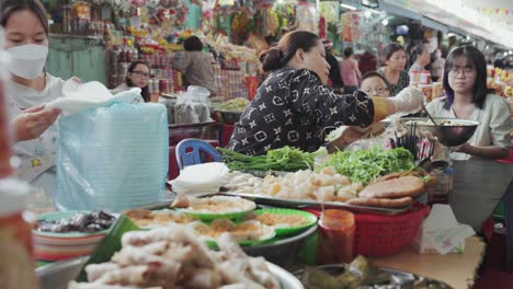 Local-vendors-and-traditional-stalls-sell-foods,-fruits,-vegetables,-and-clothes-at-busy-and-colorful-Con-Market-in-Danang,-Vietnam-in-Asia