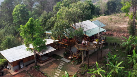 Couple-having-breakfast-on-terrace-of-luxurious-treehouse-in-jungle