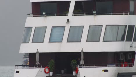 Close-up-shot-of-the-stern-of-a-tourist-cruise-ship-sailing-on-the-waters-of-Ha-Long-Bay,-Vietnam