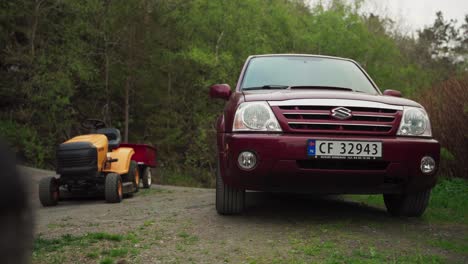SUV-Parked-Next-To-A-Lawn-Mower-At-The-Countryside