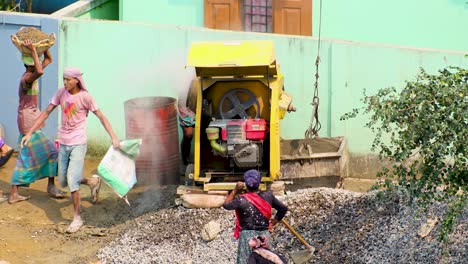The-laborer-is-working-on-a-concrete-mixer-machine-on-a-usual-day-in-Bangladesh
