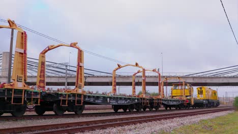 Railway-railroad-construction-train-driving-empty-wagons,-wide-shot,-camera-pan