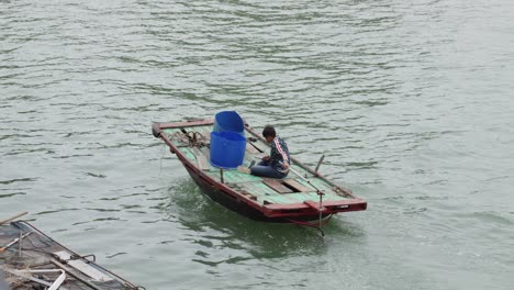 Old-Fishing-Boat-Sailing-Across-The-ocean-In-Ha-Long-Bay,-Vietnam