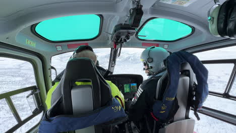 Static-shot-of-the-interior-of-a-helicopter-as-it-flies-over-mountainous-and-snow-covered-landscape