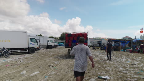 POV-of-fishermen-assisting-loaded-transport-truck-with-fish-baskets