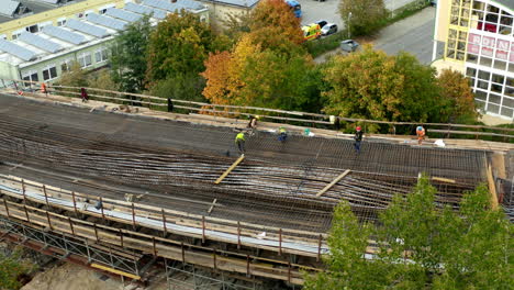 Construction-workers-working-on-metal-mesh-of-highway-road-in-progress