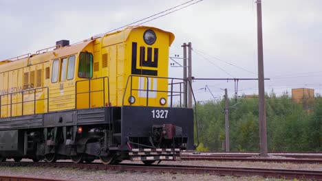 yellow-train-wagon-on-tracks,-wide-shot,-static