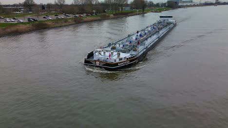 Liquid-cargo-ship-navigating-through-the-inland-canal-of-Zwijndrecht,-The-Netherlands