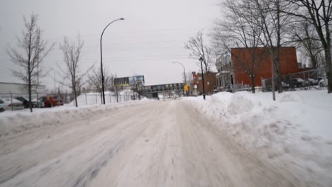 POV-Bewegung-Im-Hyperlapse-Durch-Eine-Verschneite-Straße,-Vorbei-An-Geparkten-Autos-In-Montreal,-Um-An-Der-Roten-Ampel-Hinter-Dem-Verkehr-Zu-Warten