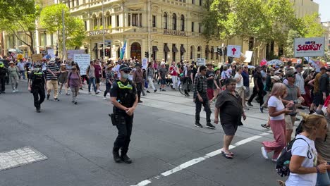 Anti-vax-and-anti-jab-protesters-in-Melbourne-marching-in-the-city-playing-drums-and-chanting-with-strong-police-presence