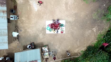 People-sitting-in-circle-and-holding-harvested-coffee-beans-in-hands