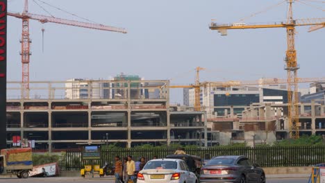 Large-construction-site-of-a-government-owned-building-with-cranes-and-workers,-HITECH-City,-Hyderabad
