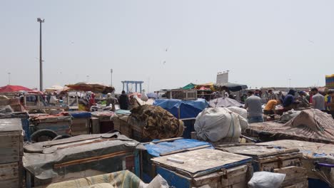 People-at-market-of-fishing-port-of-Essaouira,-Morocco