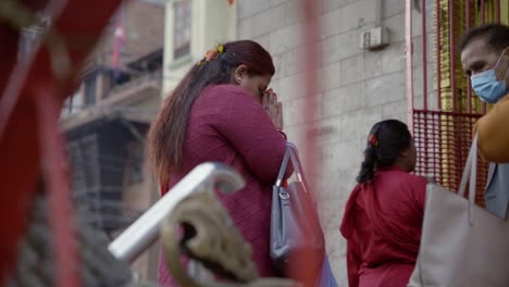 Slow-motion-of-Nepalese-Lady-praying-in-Front-of-a-Temple-In-The-District-of-Thamel-in-Katmandou