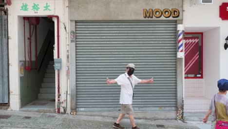 Chinese-pedestrians-walk-past-a-closed-business-with-its-door-shut-down