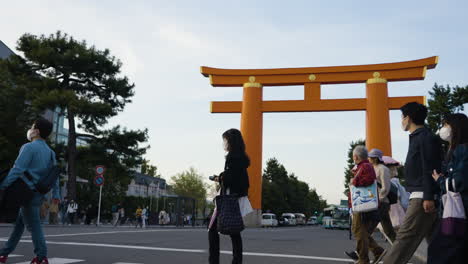 Low-slow-motion-shot-of-commuters-walking-in-front-of-an-Asian-archway