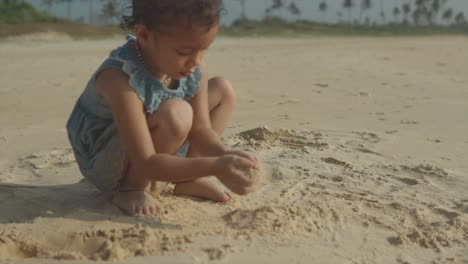A-young-girl-is-playing-with-the-sand