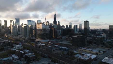 Drone-shot-over-Fulton-River,-approaching-the-high-rise-of-Loop,-sunrise-in-Chicago