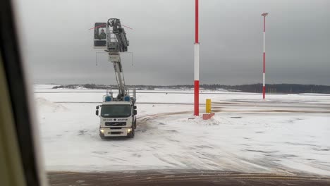 Passenger-POV-KLM-aircraft-receiving-de-icing-treatment-before-take-off-from-Helsinki-Vantaa-International-airport