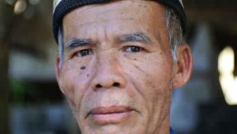 Close-up-portrait-shot-of-Old-Malay-Man-relaxing-in-the-morning-in-front-of-his-house