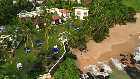 Aerial-view-around-a-beach-and-the-Teardrop-hotels-resort,-sunset-in-Sri-Lanka