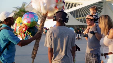 A-street-seller-sells-cotton-candy-and-colorful-ballons-at-Praca-Maua,-in-the-center-of-Rio-e-Janeiro,-Brazil