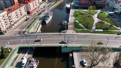 In-the-city-of-Klaipeda,-the-Danes-River-flows,-and-the-Castle-Bridge,-one-of-the-main-bridges-of-the-city,-passes-through-it